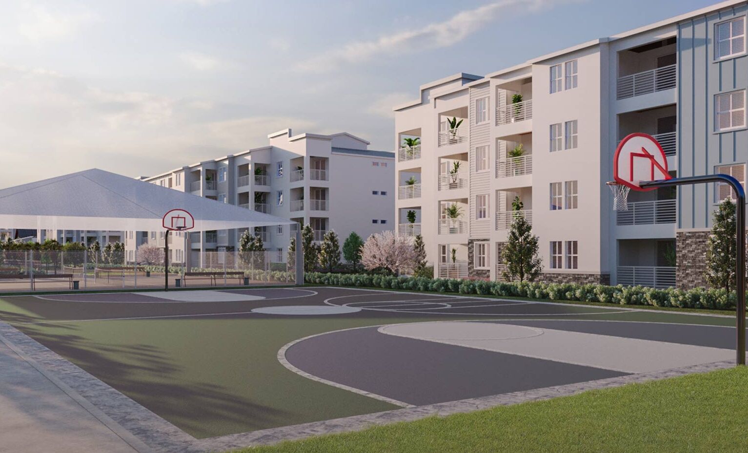 A modern residential building with multiple balconies, a basketball court, and a covered area.