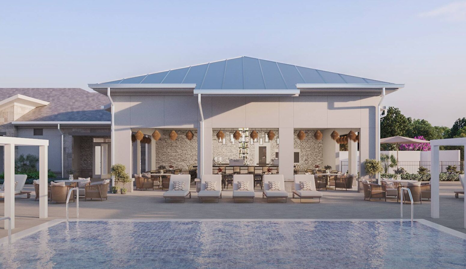 A modern outdoor pool area with lounge chairs and a bar area.