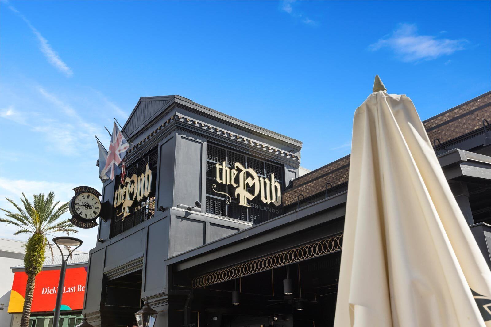 A building with a sign reading "the Pub" and a clock on the left.
