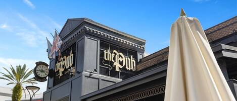 A building with a sign reading "the Pub" and a clock on the left.