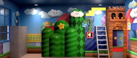 A room with a blue ceiling, a window, a door, a wall with a mountain and clouds design, and a ladder.