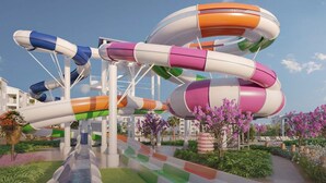 A water park with multiple slides in various colors, surrounded by greenery and flowers. - Vor5592aa: 5 Bed, Gamer's Paradise, Pool (Orlando)