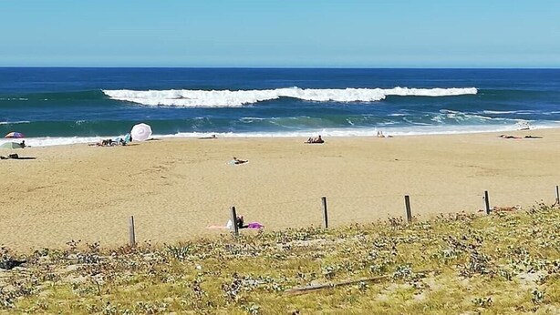 A beach with waves, a sandy shore, and a clear sky. - Fully Renovated and Air-Conditioned T3 Apartment in Southern Basque Country and Landes (Tarnos)