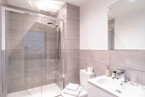 Shower, hair dryer, towels, shampoo