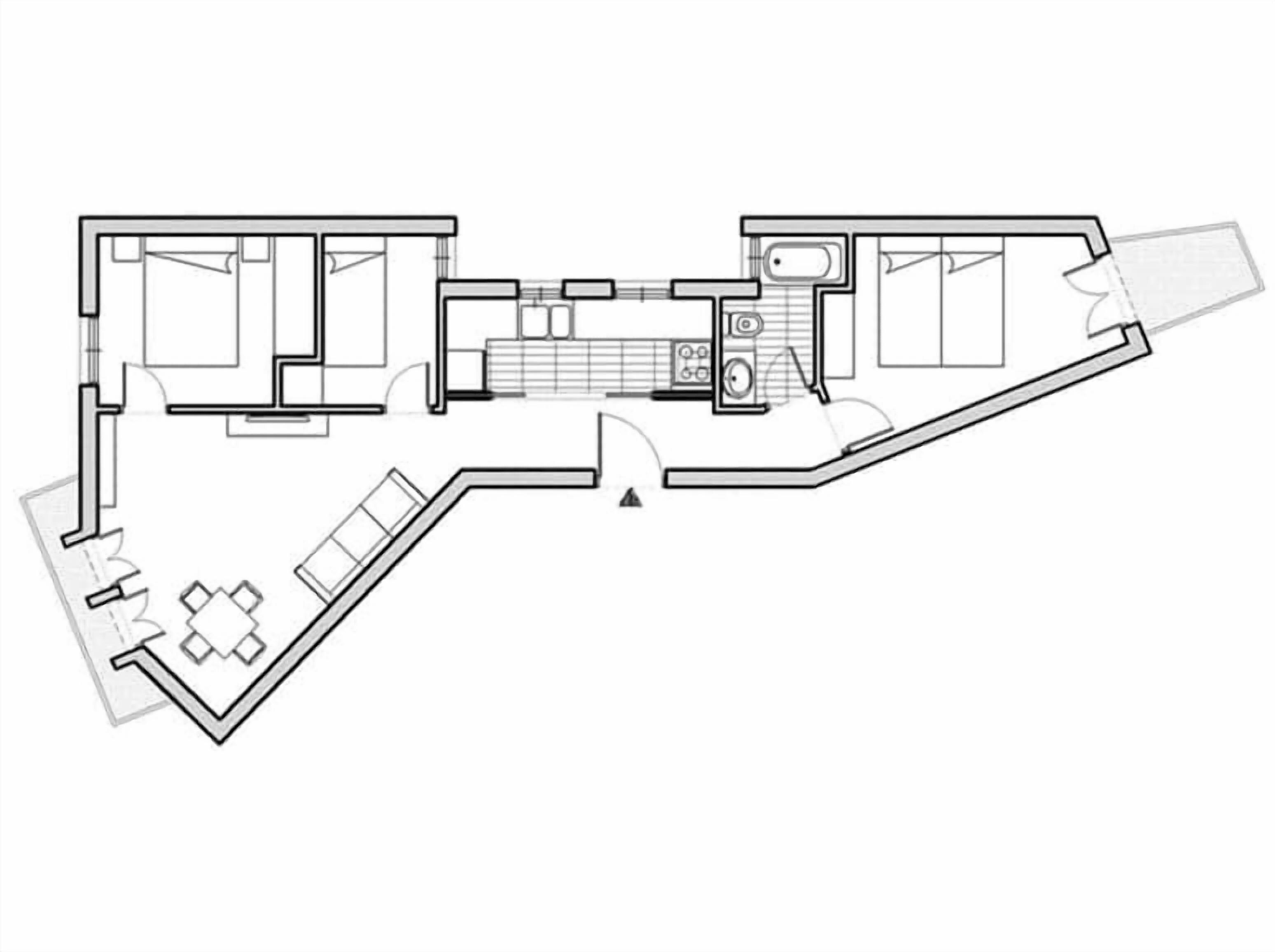 A floor plan of a hotel room with a bathroom, kitchenette, and a seating area.