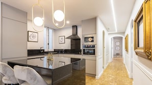 A modern kitchen with a central island, stainless steel appliances, and pendant lighting. - Contemporary apartment in Valencia city center with Wifi and air conditioning (Valencia)