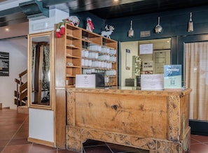 A reception desk with a wooden design, a sign for WiFi, and a holiday sign.