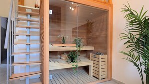 A compact, modern room with a built-in wooden shelf unit, a small desk, and a potted plant. - La Cà Fiera 11E. (Bologna)