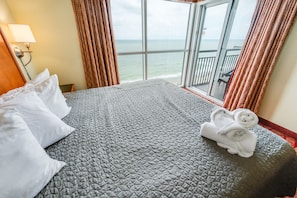 Relax in comfort with a large bed and sea views from the balcony.