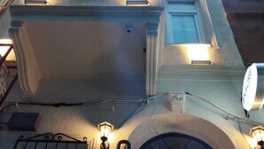 A building with multiple windows and a central entrance with a decorative arch. - Taksim Nacre 360 Suit (Istanbul)