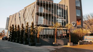 A modern hotel with a geometric facade, balconies, and a sign reading "HOTEL CARPE DIEM." - Hotel Carpe Diem Mostar (Mostar)
