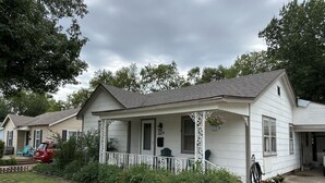 A single-story house with a porch, a number '224' on the door, and a red car parked in the driveway. - The Walnut House - Right at OSU Greek Row and blocks from Theta Pond (Stillwater)