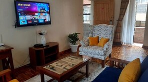 Relax in style with a flat-screen TV, comfortable sofa, and cozy armchair.