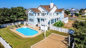 A large two-story house with a swimming pool, a covered patio, and a fenced backyard. - New - Pool,Game Room,Access 2 Beach,Golf Community (Corolla)