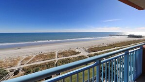A balcony with a view of a beach and a pier. - RT-0703 Oceanfront 1-Bedroom Condo at Roxanne Towers, Myrtle Beach - Sleeps 6 (Myrtle Beach)