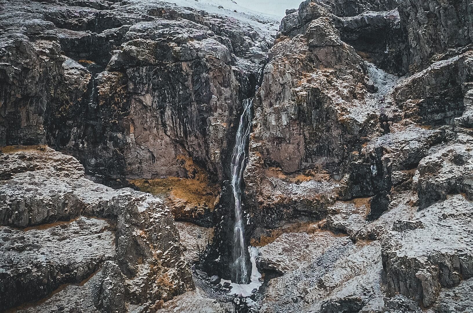 A waterfall cascading down a rocky cliff.
