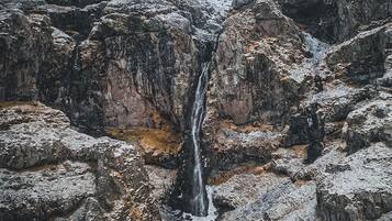 A waterfall cascading down a rocky cliff.