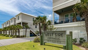 A row of West Side Cottages with a sign indicating the address 1592 W. Beach Blvd. - West Side Cottages N - Your Gulf Shores Paradise Awaits (Gulf Shores)