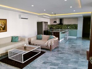 Relax in this stylish living room with a beige sofa, coffee table, and patterned rug.