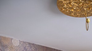 A modern kitchen with a patterned backsplash, a central island, and a dining area with a black table and gold placemats. - House 30 meters from the UNESCO monuments of San Vitale and the Galla Placidia (Ravenna)