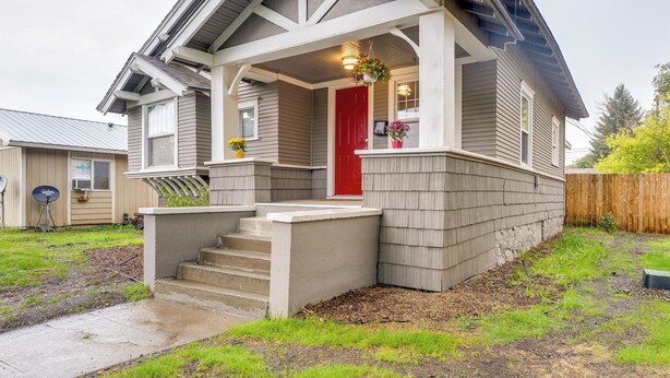 A single-story house with a front porch, a red door, and a small front yard. - Spokane Vacation Rental w/ Central Location! (Spokane)