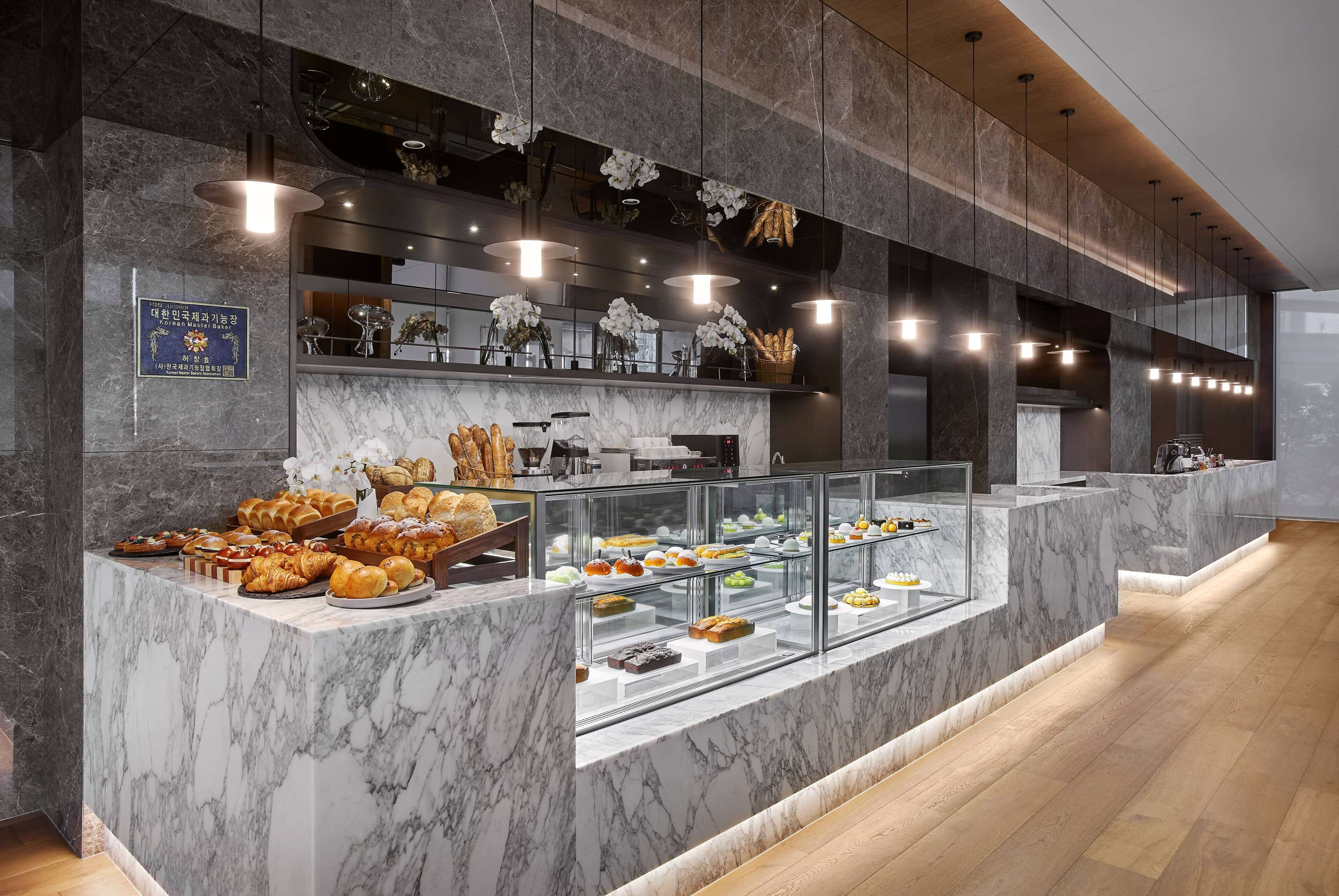 A marble counter with a variety of baked goods and pastries.