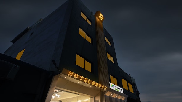 A hotel with a modern design, featuring a prominent 'HOTELURBAN' sign and a 'treebo' sign indicating an associated brand or service. - Treebo Urban, 1 Km From Railway Station (Surat)