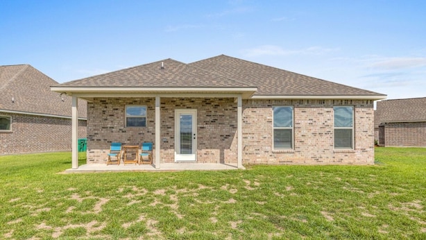 A residential building with a brick facade, a covered porch, and a lawn in front. - Hideaway Spot Where Southern Charm Stays - LT7950 (Calcasieu Parish)