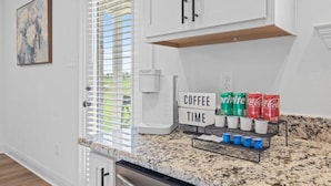 A kitchen with white cabinets, a coffee maker, and a sign that says 'COFFEE TIME'. - Hideaway Spot Where Southern Charm Stays - LT7950 (Calcasieu Parish)