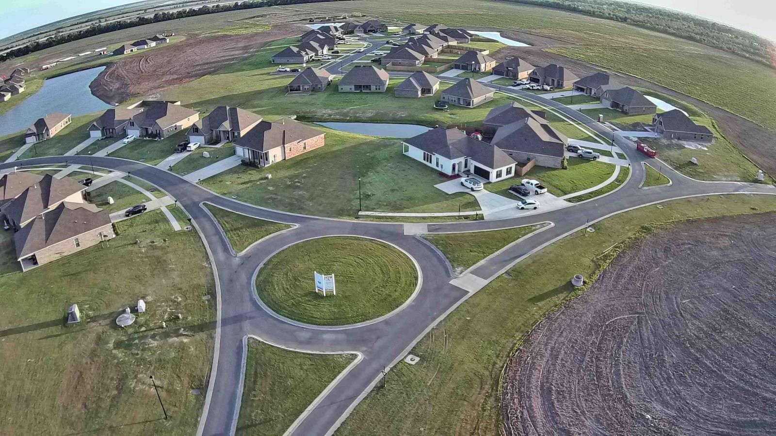 A residential area with houses, roads, and a central roundabout.