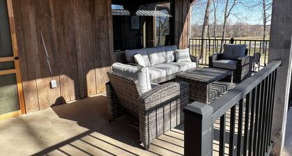 Rustic Lodge with a view of open pastures and bison grazing on the land.