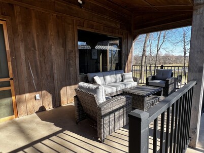 Rustic Lodge with a view of open pastures and bison grazing on the land. 