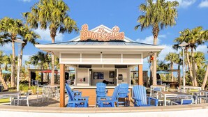 A beachside restaurant named 'PUMBRELLAS' with outdoor seating and palm trees. - Luxury Retreat: Windsor Island Villa with Private Pool and Game Room (Davenport)