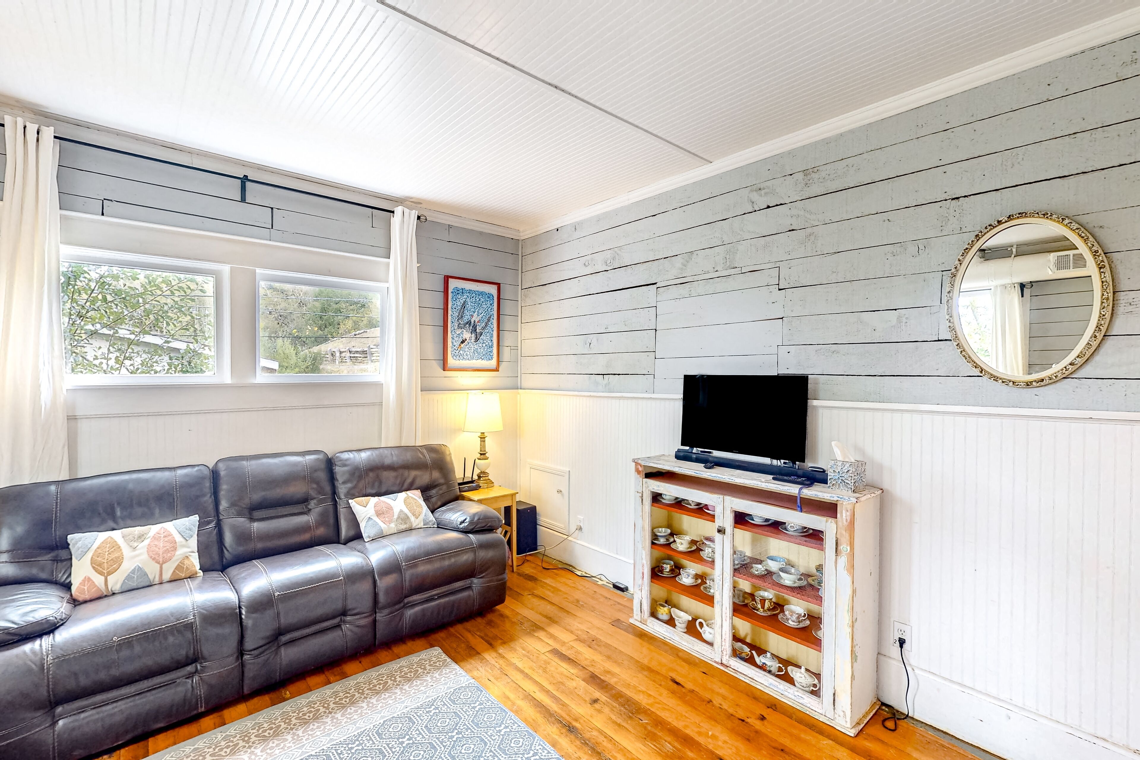 Turn-of-the-century home near beaches with porch, fenced yard & fireplace