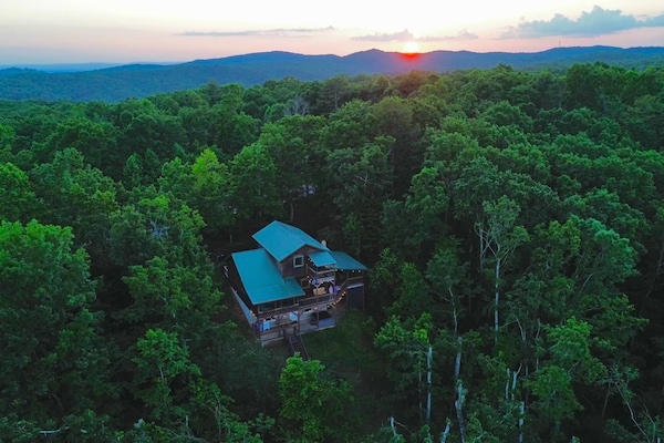 View of the back of the house with sunset in the background.