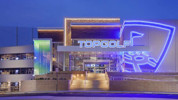 A modern building with a prominent 'TOPGOLF' sign, featuring a staircase leading to the entrance. - Spring 25% Discount is here, 1King bed, Near NYC (Hoboken)