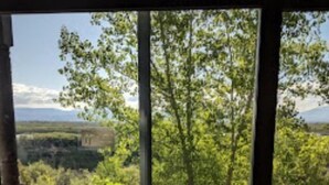 A balcony with a view of a forest and mountains. There are two chairs and a small table. - Stunning, sought after David Walley's Amazing Resort in the beautiful mountains! (Genoa)