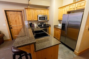 Fridge, oven, toaster, dining tables