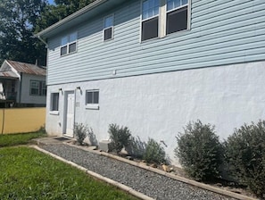 A two-story house with a white exterior and a front door.