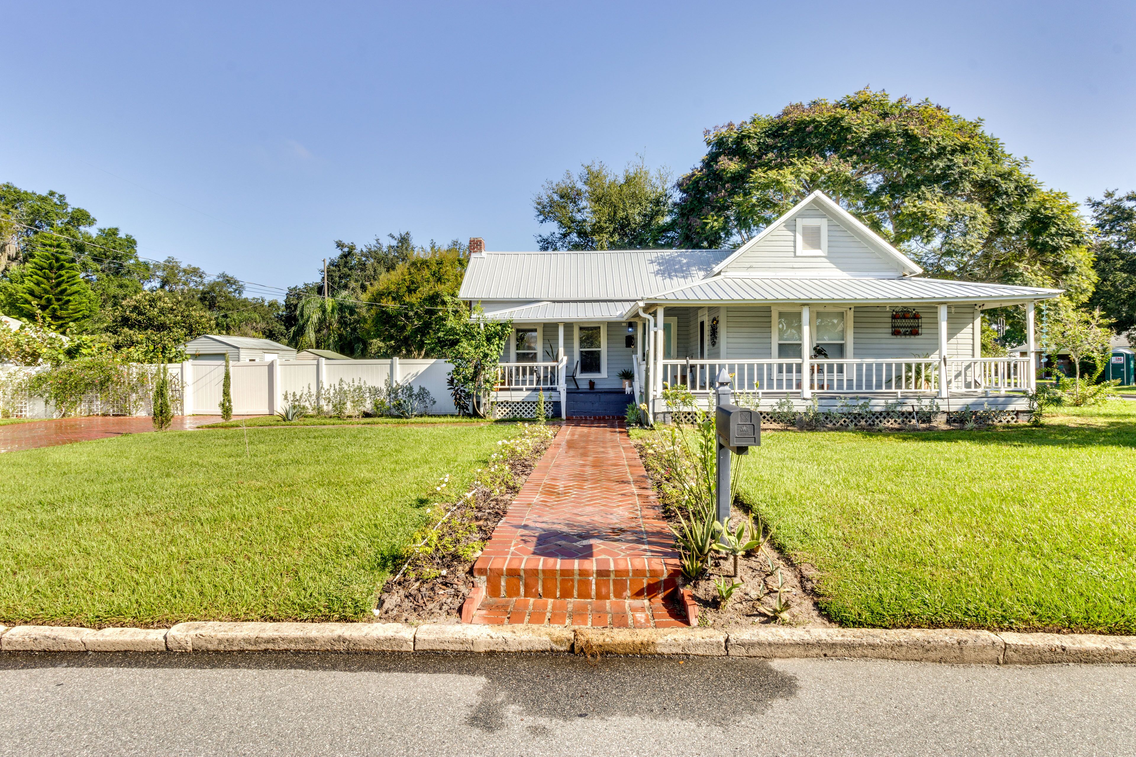 A single-story house with a front porch, a brick pathway leading to the entrance, and a well-maintained lawn.