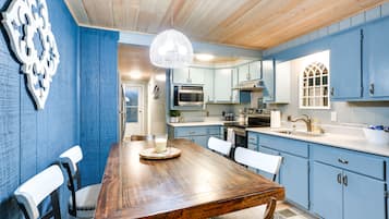 Enjoy meals for two at the kitchen table, complete with a glass of milk and modern appliances.