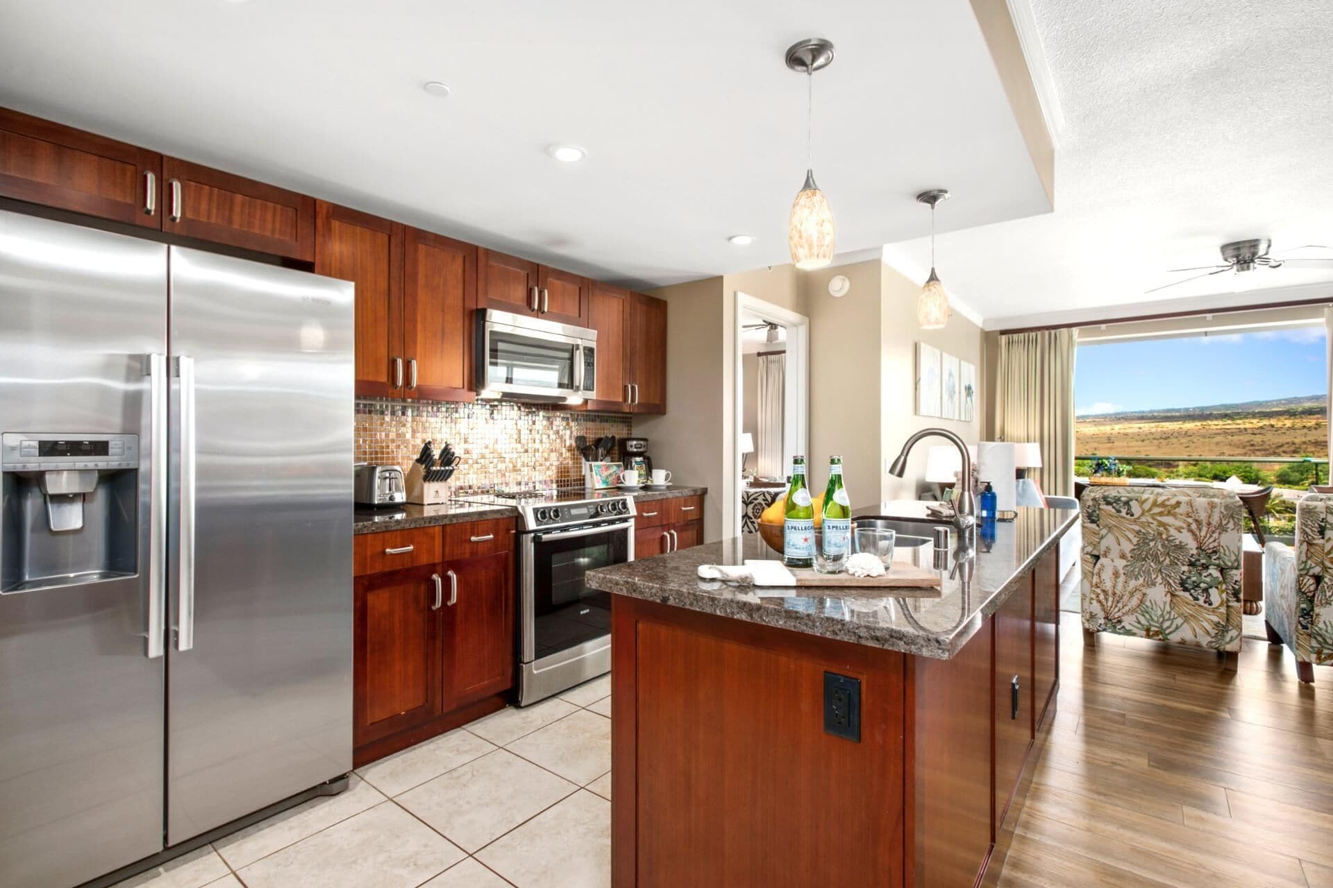 A modern kitchen with stainless steel appliances, wooden cabinets, and a large island.