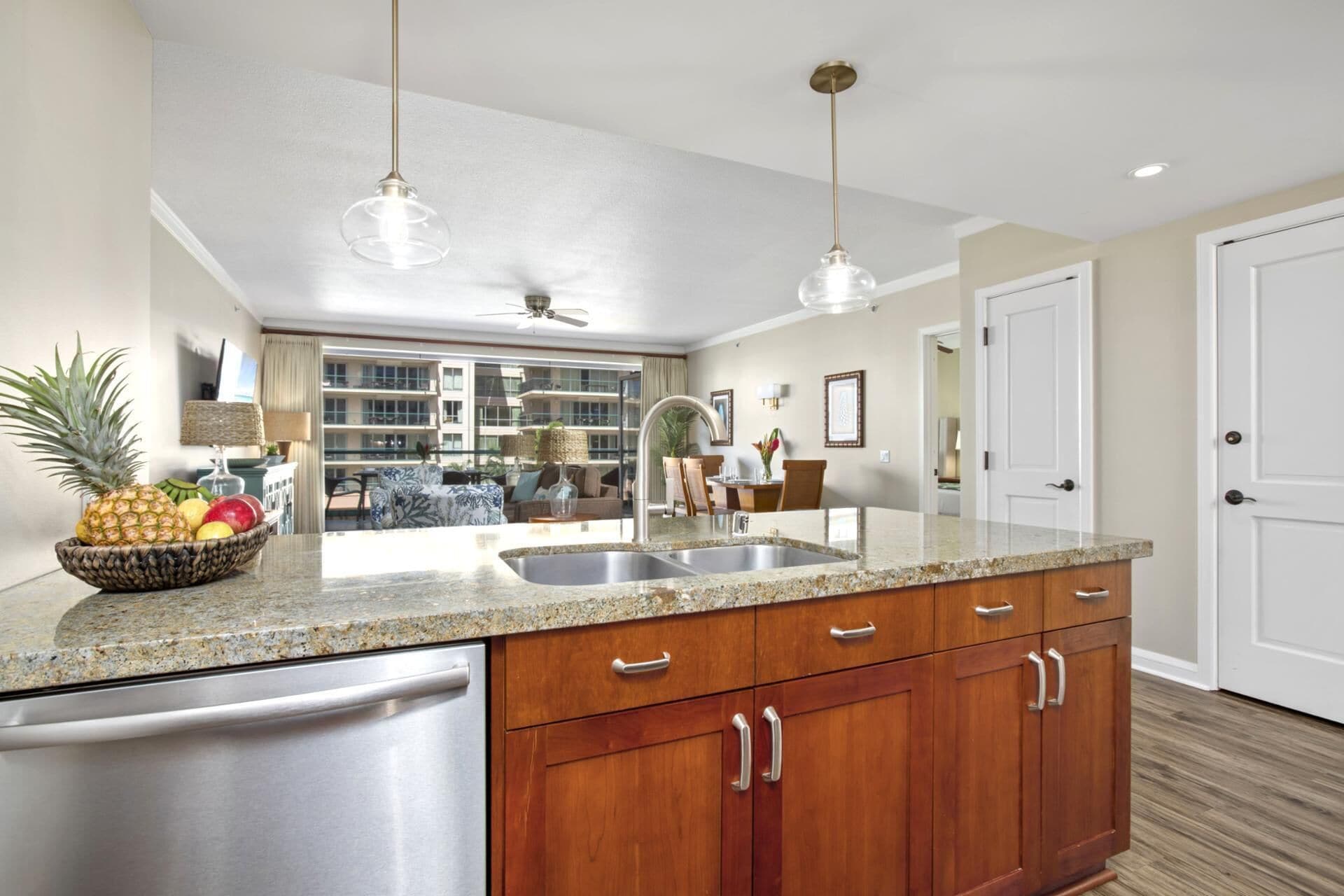A modern kitchen with granite countertops, stainless steel appliances, and wooden cabinets.