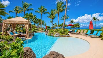 Outdoor pool, a waterfall pool, pool umbrellas, sun loungers
