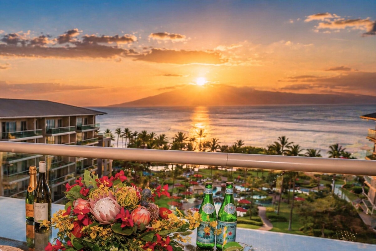 Un balcon offrant une vue sur le coucher du soleil, des bouteilles et une composition florale.