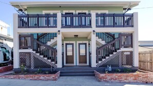 A two-story building with a balcony on the upper floor, a front entrance with double doors, and a number '2919' sign. - Charming Studio Balboa Park W/D (San Diego)