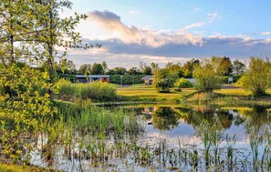Escape to a serene lakeside haven with a tranquil reflection of the surrounding landscape.