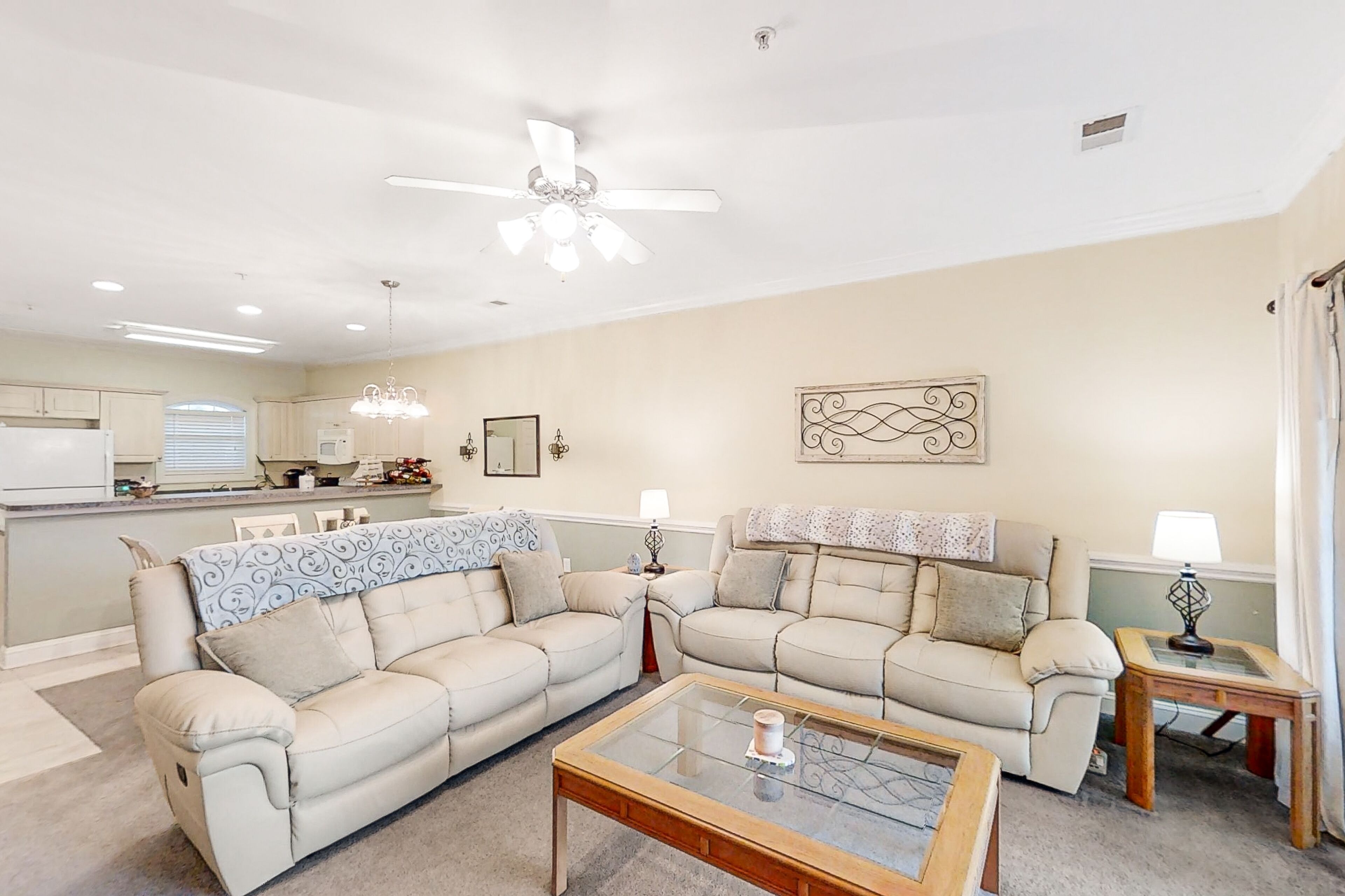 Ground-floor condo with water views, patio, W/D, pool access, & on-site grill
