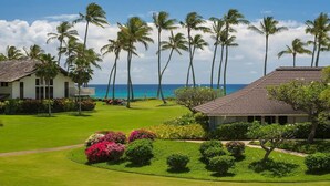 A resort with a well-maintained lawn, palm trees, and a view of the ocean. - Kiahuna Paradise @ Poipu with 2  AC units 
Family size condo with patio (Koloa)