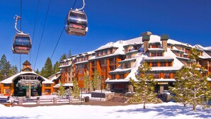 A snow-covered building with multiple floors, ski lifts, and a small building with a clock. - Marriott's Timber Lodge - Ski-In & Ski-Out - Sleeps 8! (South Lake Tahoe)